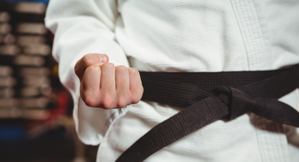 A karate student making a karate knuckles facing down fist